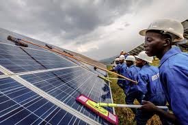 Technicians installing solar panels on a newly built structure